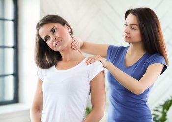 Woman is getting physical therapy from a professional doctor